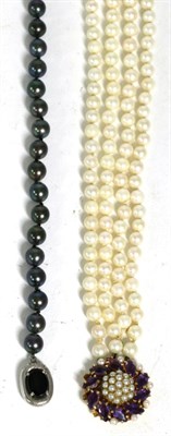 Lot 253 - A black cultured pearl necklace, uniform cultured pearls knotted to an onxy set clasp, stamped...