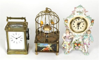 Lot 285 - A brass carriage timepiece, ceramic timepiece and a novelty bird cage timepiece (3)