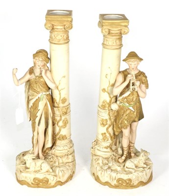 Lot 315 - A pair of Royal Dux figures of a shepherd and shepherdess, each modelled standing beside a...