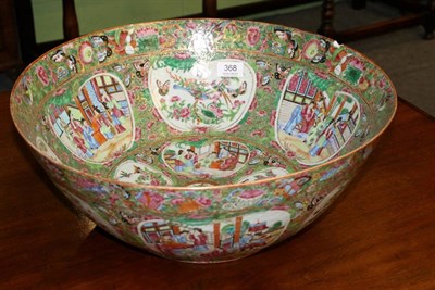 Lot 368 - A Cantonese porcelain punch bowl, mid 19th century, typically painted with figures in interiors and