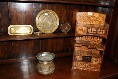 Lot 372 - A Japanese inlaid wood display stand; four items of Cairo ware and a brass vessel (6)