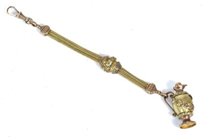 Lot 381 - A triple strand gilt metal Albertina with clip, suspending a ewer charm with applied floral...