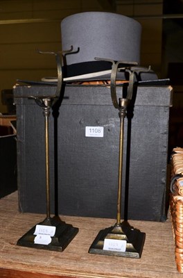 Lot 1108 - A pair of 19th century brass shoe stands and a top hat in case (3)