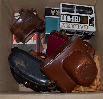 Lot 1125 - A box of assorted camera equipment including Zenit Camera, Zeiss Ikon accessories etc