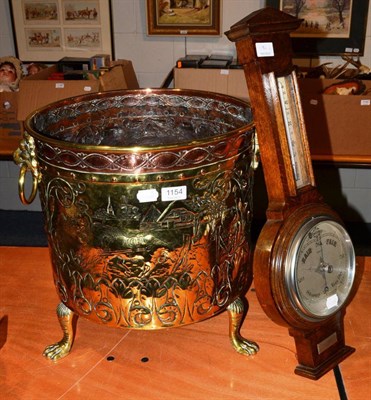 Lot 1154 - A copper embossed coal scuttle and an aneroid barometer retailed by Harrods