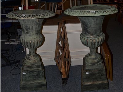 Lot 1180 - A pair of large urns on stands