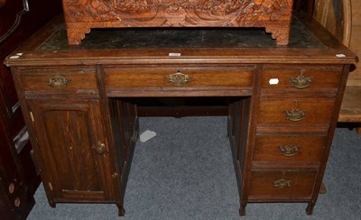 Lot 1186 - An Edwardian oak pedestal desk, early 20th century, with green leather top, with six drawers...