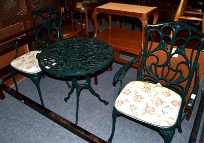 Lot 1197 - A green painted metal garden table and two garden chairs