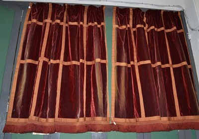 Lot 1213 - A pair of rust coloured silk velvet curtains with applique ";trellis shape"; trim and fringing