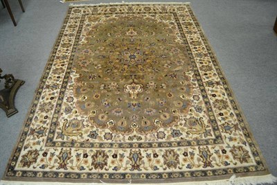 Lot 1216 - An Indian carpet, the mushroom floral field with central medallion framed by spandrels and...