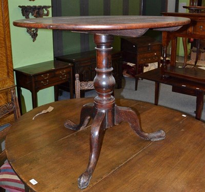 Lot 1345 - A Georgian oak tripod table