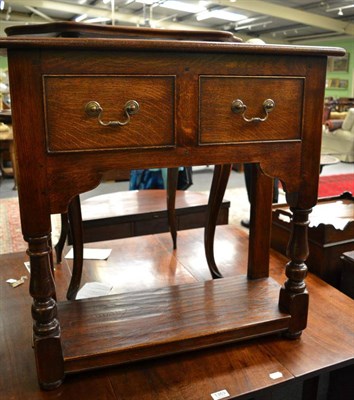 Lot 1352 - A 20th century oak side table fitted with two drawers in the style of Titchmarsh & Goodwin