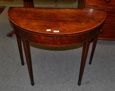 Lot 1359 - A George III mahogany demi-lune fold over card table