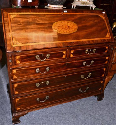 Lot 1361 - A George III inlaid mahogany bureau on bracket feet, with rococo style handles