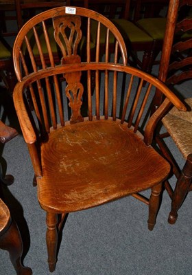 Lot 1367 - An oak and yew Windsor armchair with crinoline stretcher