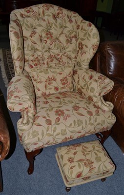 Lot 1373 - A modern button back wing armchair, in 18th century style, with foliate upholstery; together with a