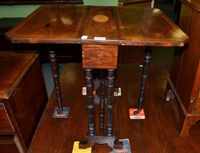 Lot 1410 - An Edwardian line inlaid rosewood Sutherland table