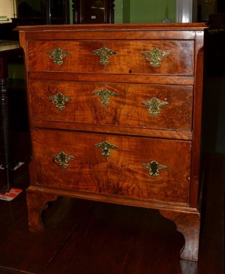 Lot 1411 - A small walnut and oak three height chest of drawers