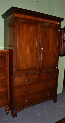 Lot 1418 - A George III mahogany linen press, enclosing four slide out trays, on bracket feet