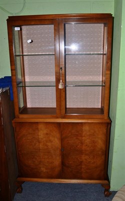 Lot 1426 - A mid 20th century glazed display cabinet with cupboard below