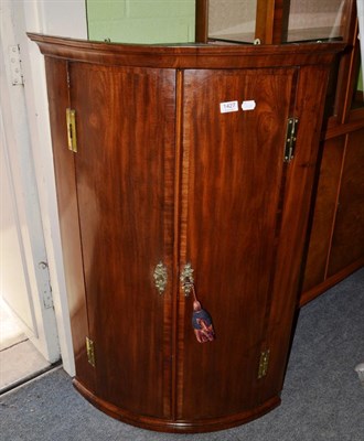 Lot 1427 - A crossbanded mahogany corner cupboard