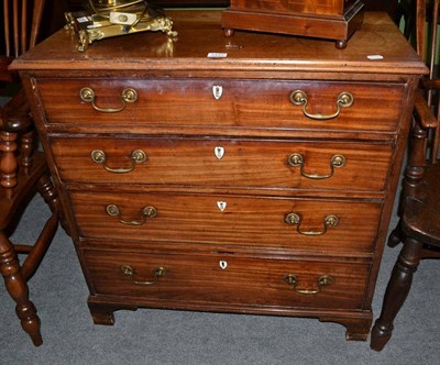 Lot 1431 - A small George III mahogany four height chest of drawers on bracket feet