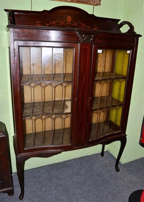 Lot 1436 - An Edwardian line inlaid serpentine fronted display cabinet