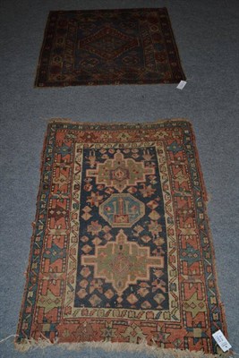 Lot 1444 - A Heriz rug, Iranian Azerbaijan, the indigo filed with three medallions enclosed by terracotta...