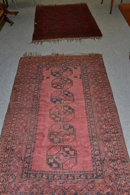 Lot 1447 - An Turkmen rug, North Afghanistan, the claret field with two columns of elephant foot guls,...