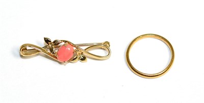 Lot 132 - A 22 carat gold band ring, finger size M1/2 and a 9 carat gold coral brooch, an oval cabochon coral