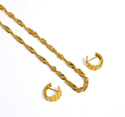 Lot 137 - A pair of faceted hoop earrings, measure 1cm long, with post fittings, and a twisted fancy link...