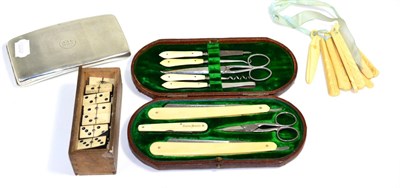 Lot 142 - A silver cigarette case; carved teething sticks; dominoes etc