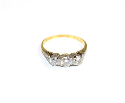 Lot 147 - An 18 carat gold three stone diamond ring, graduated round brilliant cut diamonds in claw settings