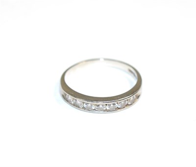 Lot 148 - A platinum half hoop ring, channel set with seven round brilliant cut diamonds, total estimated...