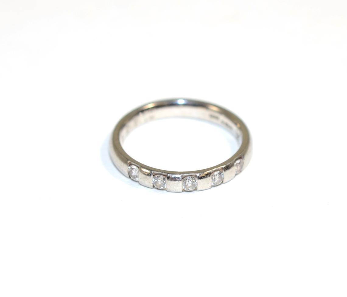 Lot 149 - A platinum diamond ring, channel set with five round brilliant cut diamonds, total estimated...
