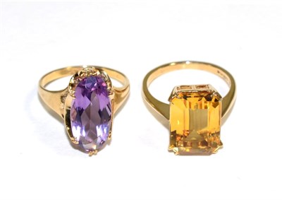 Lot 162 - A 9 carat gold amethyst ring, an oval cut amethyst in a double claw setting, to a tapering...