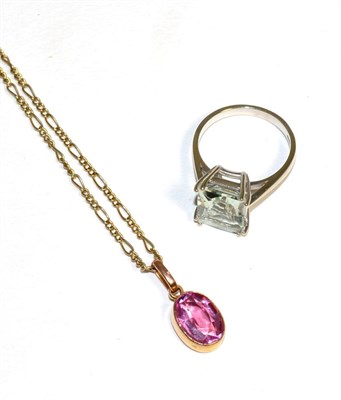 Lot 169 - A pink tourmaline pendant, an oval cut pink tourmaline in a rubbed over setting, to a figaro...
