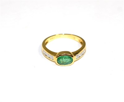 Lot 175 - An 18 carat gold emerald and diamond ring, an oval cut emerald in a rubbed over setting, to channel
