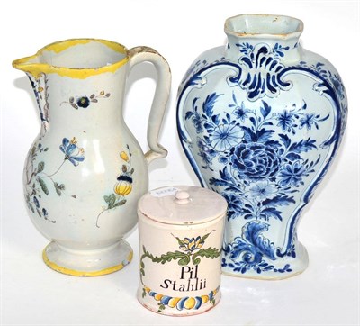 Lot 251 - An 18th century Delft vase, an 18th century faience jug and a 19th century faience jar and cover