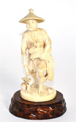 Lot 257 - An ivory okimono figure depicting a gentleman, circa 1900 (a.f.)