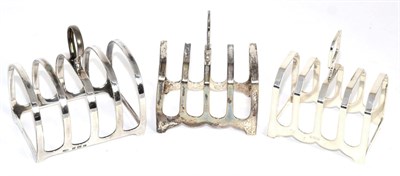 Lot 264 - Three silver toast racks