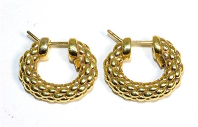 Lot 328 - A pair of rope motif hoop earrings, measure 1.5cm by 2cm, stamped '750', with hinged post fittings