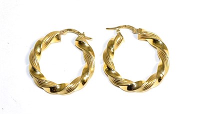 Lot 331 - A pair of twisted hoop earrings, measure 3cm in diameter, with hinged fittings, stamped '750'