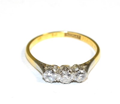 Lot 334 - A diamond three stone ring, graduated old cut diamonds in claw settings, to knife edge...