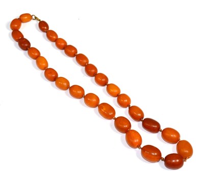 Lot 337 - An amber bead necklace, graduated oval amber beads, knotted to a jump ring, length 69cm, gross...