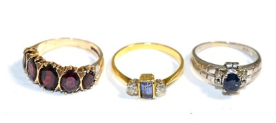 Lot 339 - An 18 carat gold sapphire and diamond three stone ring; a baguette cut sapphire in a rubbed...