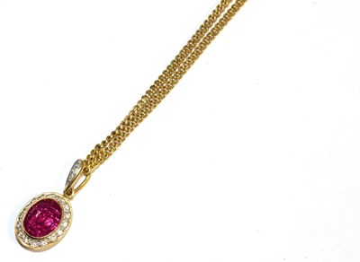 Lot 345 - A ruby and diamond pendant, an oval-shaped cluster of calibré cut rubies in a rubbed over setting