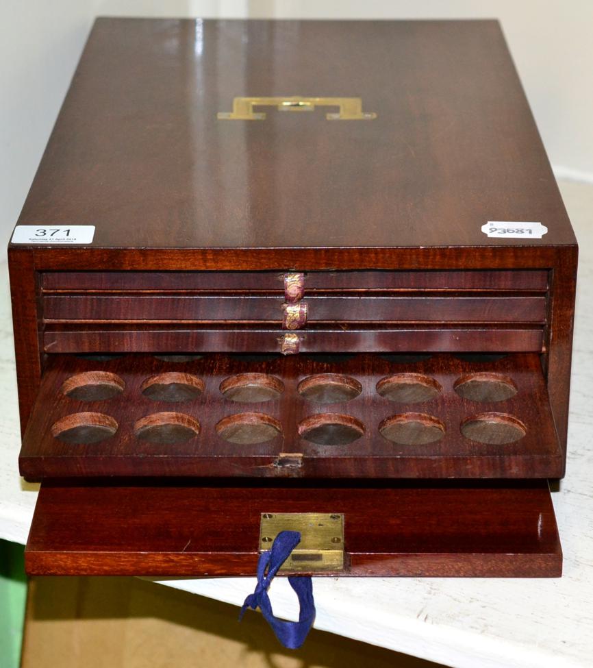 Lot 371 - A mahogany coin collectors cabinet with brass campaign handle