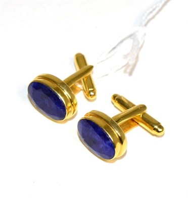 Lot 394 - A pair of glass filled sapphire cufflinks, oval cut sapphires in rubbed over settings, to...