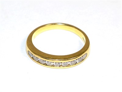 Lot 400 - An 18 carat gold diamond half hoop ring, channel set with nine round brilliant cut diamonds,...